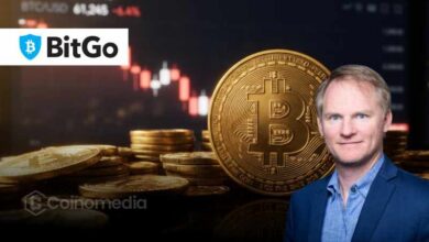 Illustration of a Bitcoin wallet containing 100 BTC alongside AI security imagery, representing BitGo CEO Mike Belshe's challenge to Anthropic's Claude.